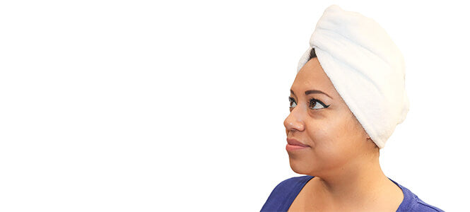 female wearing a beige hair towel side view