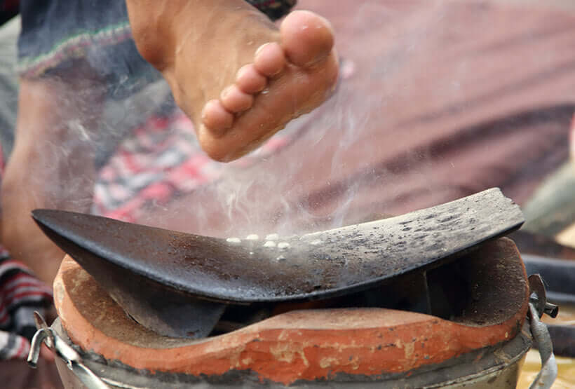 Foot over clay fire-pot receiving heat therapy in Preparation for Thai massage in Northern style.