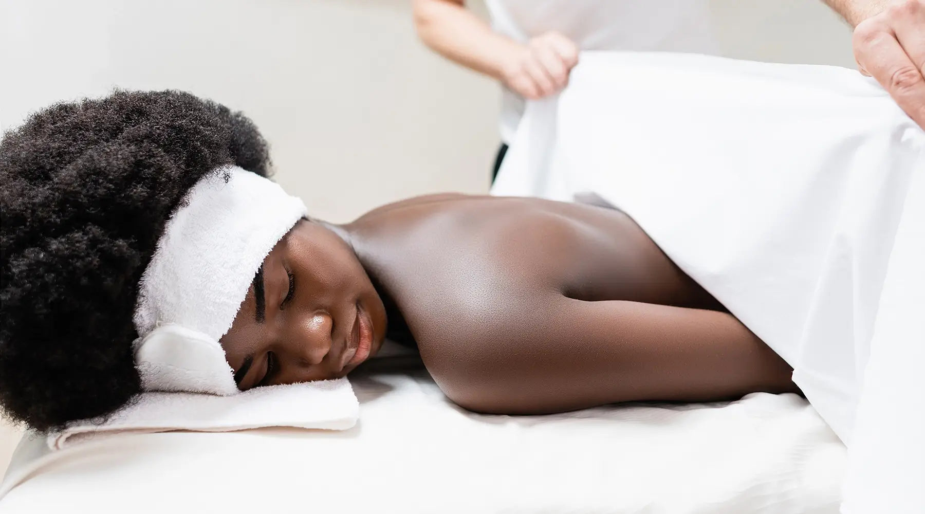 Bodybest person receiving a massage with a towel on their head