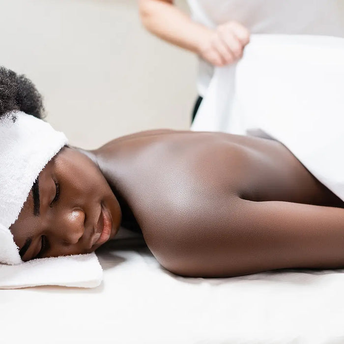 Bodybest person receiving a massage with a towel on their head