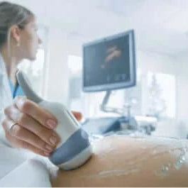 Therapist using ultrasound lubricants on a patient during an examination
