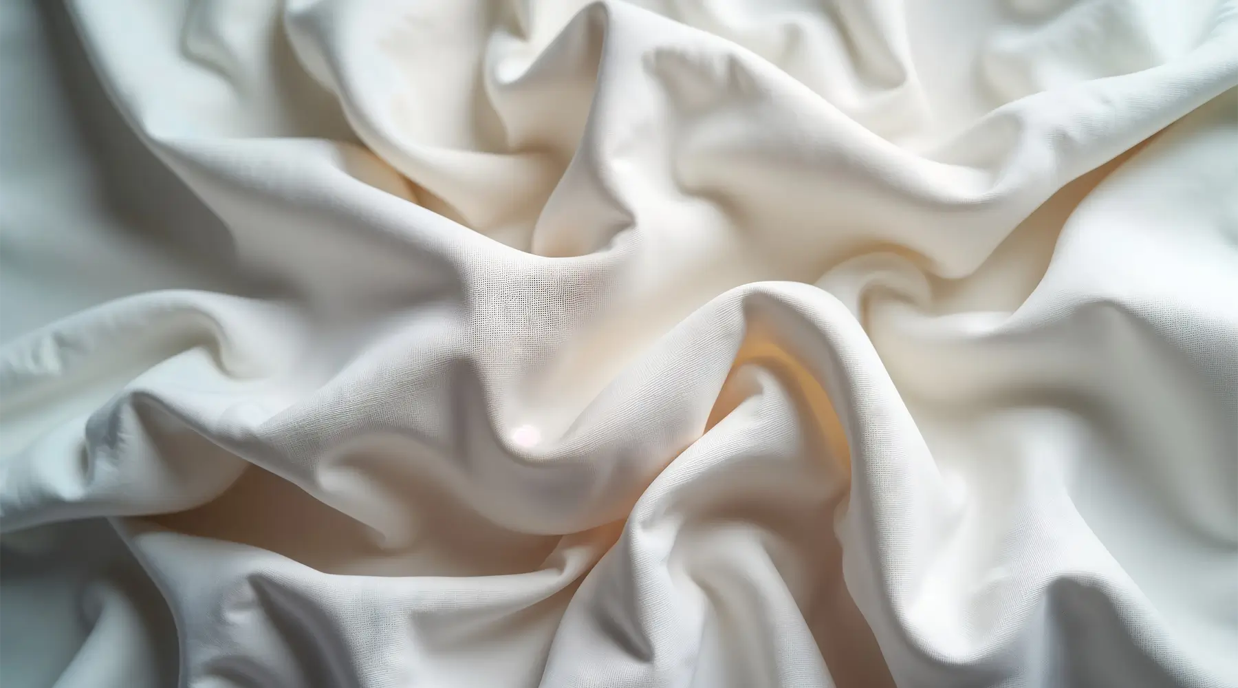 Close-up comparison of smooth white percale fabric and soft flannel massage sheet texture for professional treatment table linens