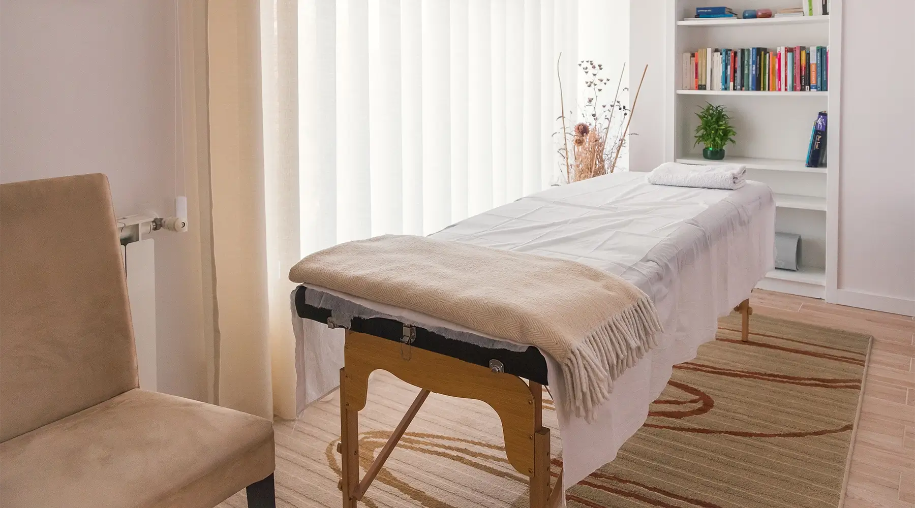 Professional massage treatment room with portable massage table illustrating common treatment table widths used by Canadian therapists