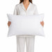 Body Best T220 percale pillowcase displayed on a 21 x 34 inch pillow held in hand to show size and fit, soft white fabric with smooth hotel-style finish