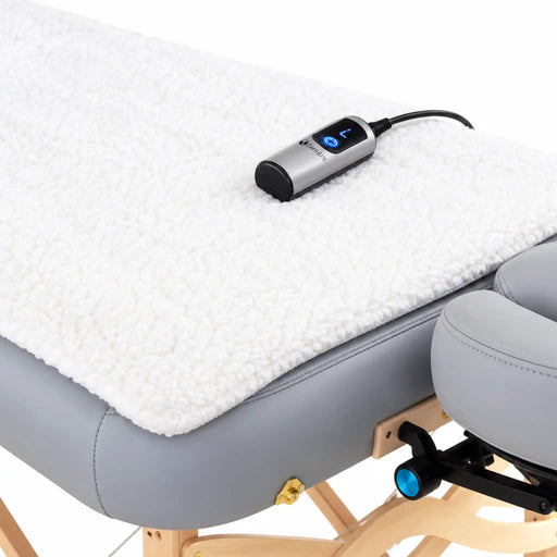 Earthlite Professional Table Warmer with soft white fleece covering a professional massage table, featuring a digital heat controller.