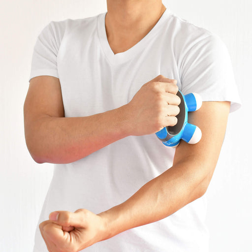 Male model demonstrating the  HoMedics Quatro Mini massager on left arm