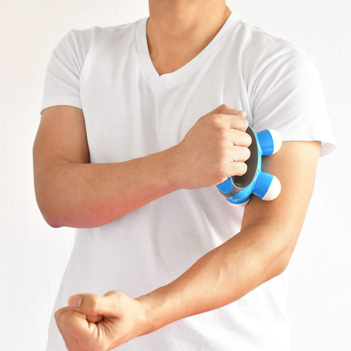 Male model demonstrating the  HoMedics Quatro Mini massager on left arm