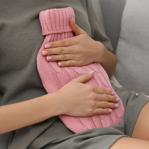 Hot Water bottle 2L being held on stomach by model