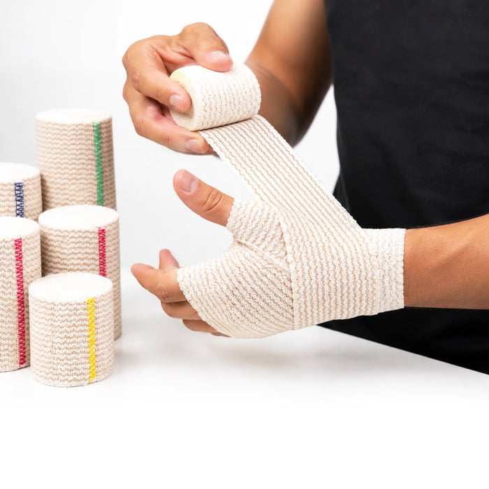 MKO Elastic Bandage being wrapped around the hand and wrist to provide compression and support.