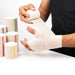 MKO Elastic Bandage being wrapped around the hand and wrist to provide compression and support.