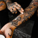 Person applying Mad Rabbit Tattoo Balm to tattooed arm