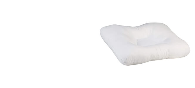 White neck support pillow by itself out of packaging showing incline of pillow