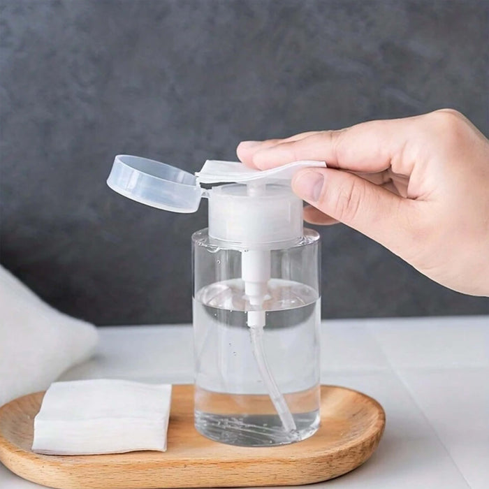 Push down dispenser bottle with clear liquid inside