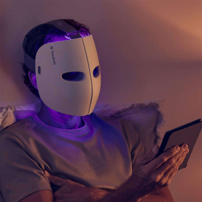 Reading a book while wearing the Thera Face Mask