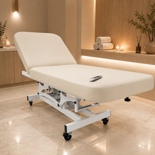 ilhouet-Tone sand-colored electric spa treatment table (Sahara Sand upholstery) shown in use in a professional spa setting