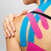 SpiderTech Tape 3 different colours blue, black and pink on left female shoulder