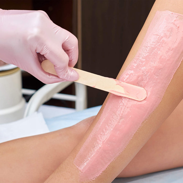 Wax or Cream wooden applicator in use on models leg