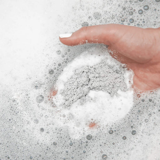 Adding Bathorium Bath Soak Charcoal Garden Detox Crush to hot bath water