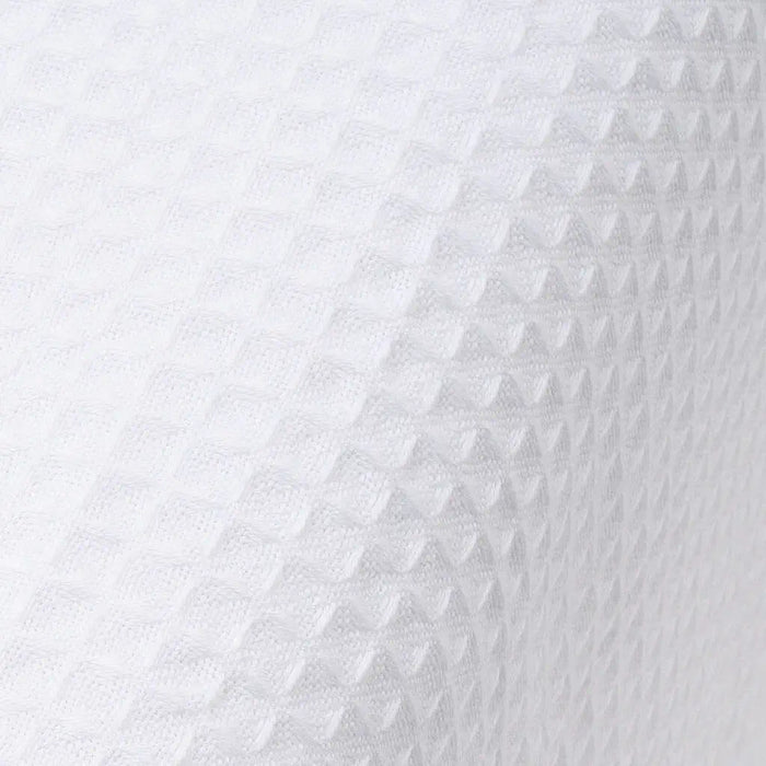 Close-up of textured white fabric with a subtle pattern