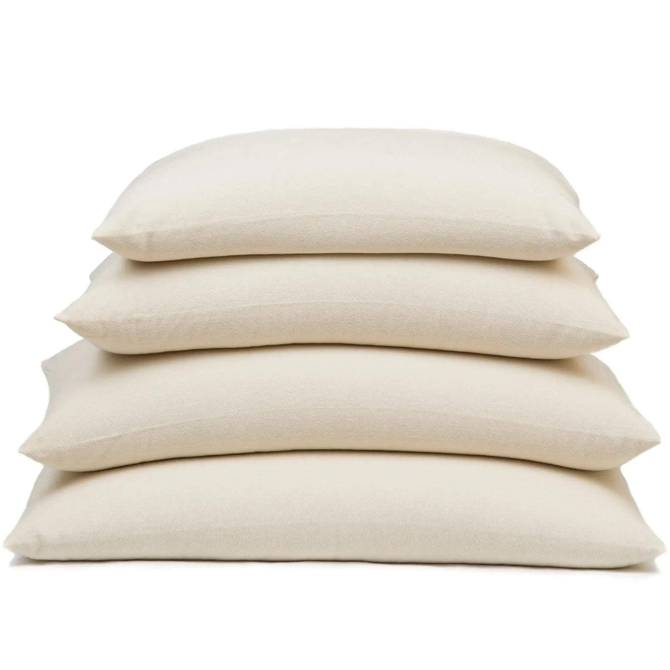 Stack of beige buckwheat stuffed pillows on a white background