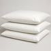 Bodybest Three white vinyl pillowcases with pillows stacked on a light gray background