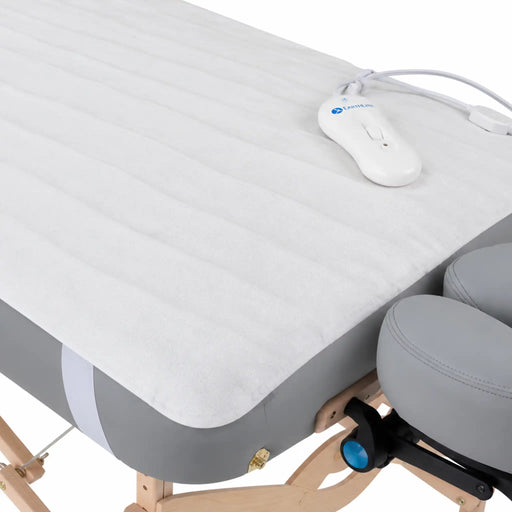 A close up view of Earthlite Bodyworker's choice massage table warmer with controller in use on massage table