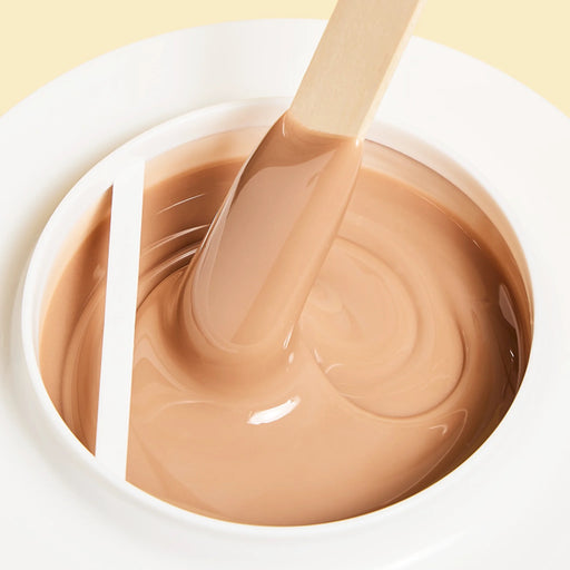 Epillyss chocolate lukewarm depilatory soft wax is in use with wooden spatula, wax consistency and wax color is being shown