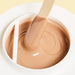 Epillyss chocolate lukewarm depilatory soft wax is in use with wooden spatula, wax consistency and wax color is being shown