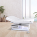 Earthlite Everest Eclipse 2.0 electric treatment table in a luxury spa treatment room with adjustable salon top, warming drawer, integrated storage, and LED-lit base