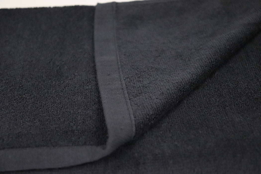 Close-up of dark gray fabric with a visible seam