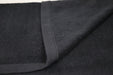 Close-up of dark gray fabric with a visible seam