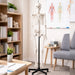 5.6-foot human skeleton budget model on a black rolling stand displayed in a clean therapist or teaching office with anatomy charts, bookshelf, and chair in the background