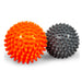 Orange and gray spiked massage balls on a white background