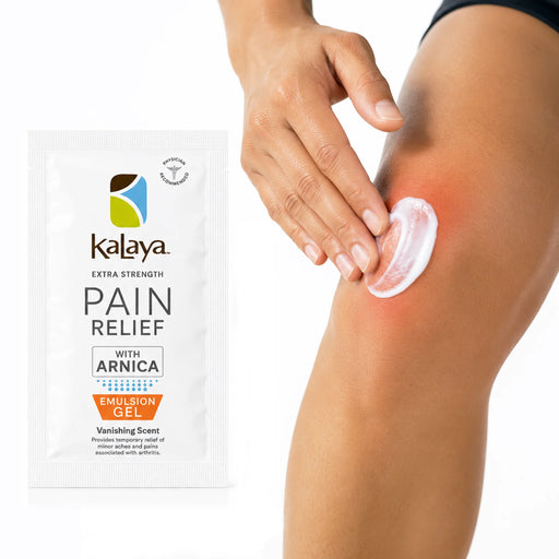 Hand applying white Kalaya Extra Strength Pain Relief Emulsion Gel with Arnica to a sore knee, with the pain relief sachet displayed beside the application area, illustrating topical use for temporary relief of minor aches and joint discomfort.