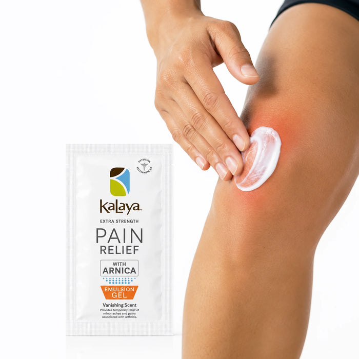 Hand applying white Kalaya Extra Strength Pain Relief Emulsion Gel with Arnica to a sore knee, with the pain relief sachet displayed beside the application area, illustrating topical use for temporary relief of minor aches and joint discomfort.
