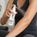 Person applying MEDISTIK Professional Natural Cold Spray to sore arm muscles for fast cooling relief from pain, tension, and inflammation.