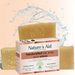 Nature's Aid handcrafted bar soap packaging box in front of three bars of pale yellow soap with a water splash graphic on a peach background.
