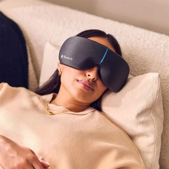 Woman relaxing while wearing Therabody Smart Goggles