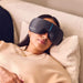 Woman relaxing while wearing Therabody Smart Goggles